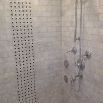 Tumbled marble and mosaic tile shower