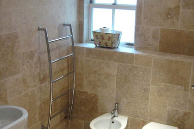 Photo of a small classic ensuite bathroom in Gloucestershire with open cabinets, a walk-in shower, a wall mounted toilet, beige tiles, stone tiles, beige walls and travertine flooring.