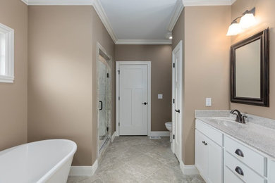 Freestanding bathtub - traditional master gray floor freestanding bathtub idea in Other with beige walls