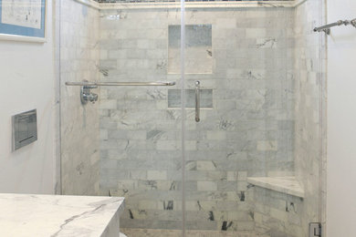 Alcove shower - small traditional kids' gray tile and marble tile marble floor and gray floor alcove shower idea in Orange County with flat-panel cabinets, white cabinets, white walls, an undermount sink, marble countertops, a hinged shower door, a wall-mount toilet and white countertops