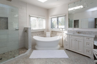 Example of a large transitional master white tile and stone tile porcelain tile bathroom design in DC Metro with shaker cabinets, white cabinets, a two-piece toilet, white walls, an undermount sink and marble countertops
