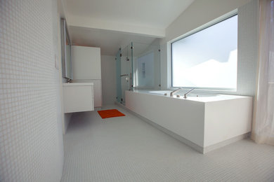 Example of a large minimalist master white tile and mosaic tile mosaic tile floor bathroom design in San Francisco with an integrated sink, flat-panel cabinets, white cabinets and white walls