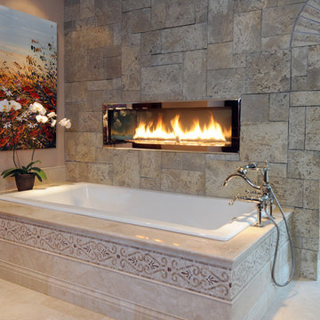 Two Sided Fireplace Above Drop in Tub with Tiled Deck