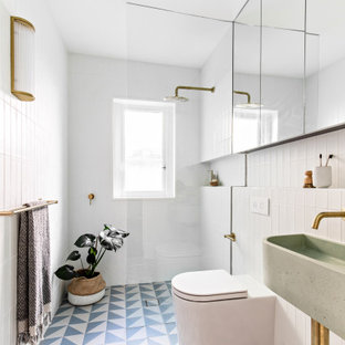 Small scandinavian master bathroom in Sydney with an open shower, a two-piece toilet, white tile, ceramic tile, white walls, porcelain floors, a wall-mount sink, blue floor, an open shower, a niche, a single vanity and a floating vanity.