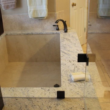 Undermount Marble Tub with Bianco Romano Granite and Frameless Shower