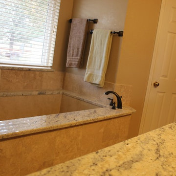 Undermount Marble Tub with Bianco Romano Granite and Frameless Shower