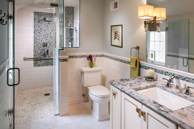 Example of a transitional white tile and ceramic tile corner shower design in Milwaukee with an undermount sink, recessed-panel cabinets, white cabinets, quartz countertops and a two-piece toilet