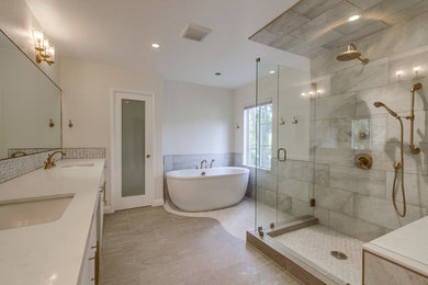 Bathroom - large transitional master gray tile and porcelain tile porcelain tile and gray floor bathroom idea in San Diego with flat-panel cabinets, white cabinets, a one-piece toilet, gray walls, an undermount sink, quartz countertops, a hinged shower door and white countertops
