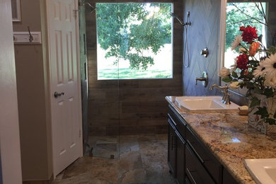 Bathroom - large traditional master brown tile and ceramic tile ceramic tile and brown floor bathroom idea in Austin with dark wood cabinets, brown walls, a drop-in sink and granite countertops
