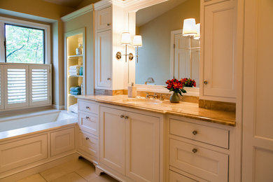 Inspiration for a mid-sized timeless master white tile and stone tile limestone floor and beige floor bathroom remodel in DC Metro with an undermount sink, furniture-like cabinets, white cabinets, marble countertops, an undermount tub, beige walls and a two-piece toilet