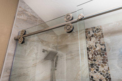 Example of a small transitional master brown tile and ceramic tile corner shower design in Phoenix with dark wood cabinets, beige walls, a vessel sink and quartz countertops
