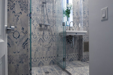 Medium sized classic shower room bathroom in New York with a corner shower, a two-piece toilet, beige tiles, blue tiles, ceramic tiles, multi-coloured walls, ceramic flooring, a wall-mounted sink and solid surface worktops.