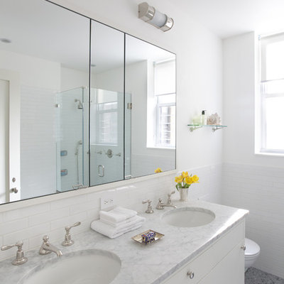 Inspiration for a mid-sized contemporary 3/4 subway tile mosaic tile floor and gray floor corner shower remodel in New York with marble countertops, flat-panel cabinets, white cabinets, white walls, an undermount sink and a hinged shower door