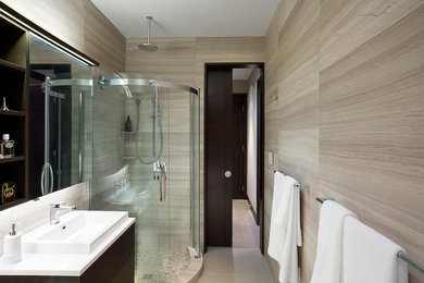 Example of a minimalist master beige tile corner shower design in Vancouver with a vessel sink, flat-panel cabinets, dark wood cabinets, quartz countertops and beige walls