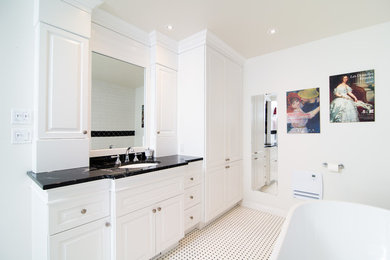 Example of a mid-sized master black and white tile and ceramic tile ceramic tile bathroom design in Montreal with raised-panel cabinets, white cabinets, a one-piece toilet, white walls, an undermount sink and granite countertops