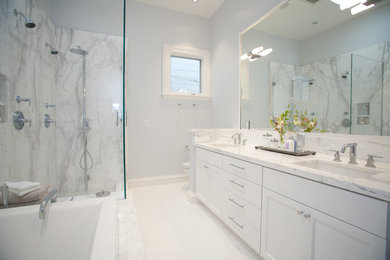 Elegant white tile bathroom photo in San Francisco with an undermount sink, recessed-panel cabinets, white cabinets, granite countertops and a two-piece toilet