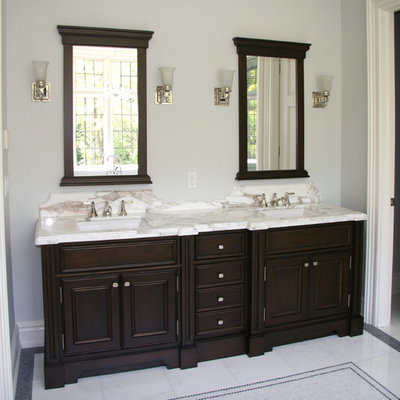 Inspiration for a mid-sized timeless 3/4 vinyl floor bathroom remodel in Toronto with recessed-panel cabinets, dark wood cabinets, blue walls, an undermount sink and solid surface countertops