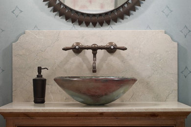This is an example of an eclectic bathroom in New York with a vessel sink.
