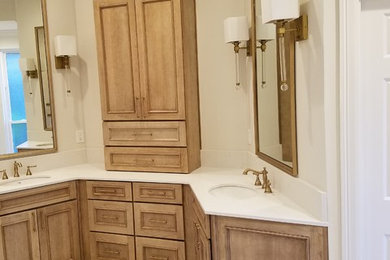 Bathroom - large traditional master marble floor and white floor bathroom idea in New Orleans with beaded inset cabinets, light wood cabinets, beige walls, an undermount sink, solid surface countertops and white countertops