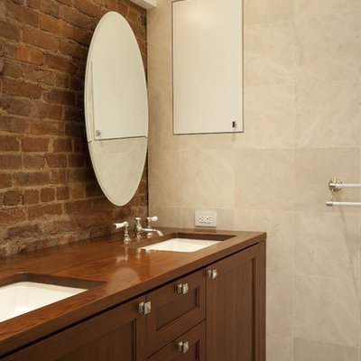 Example of an eclectic beige tile bathroom design in New York with an undermount sink, shaker cabinets and medium tone wood cabinets