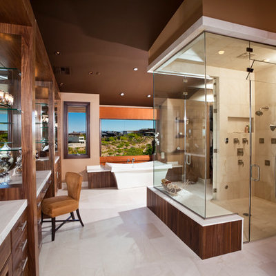 Large trendy master beige tile and stone tile marble floor bathroom photo in Las Vegas with an undermount sink, flat-panel cabinets, medium tone wood cabinets, brown walls and marble countertops