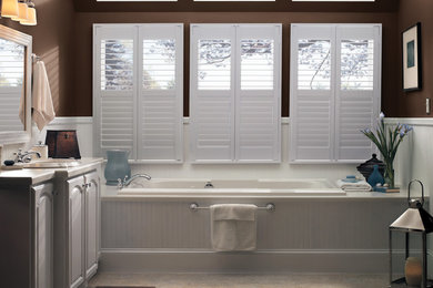 Example of a large transitional master ceramic tile alcove bathtub design in Other with raised-panel cabinets, white cabinets, brown walls and an undermount sink