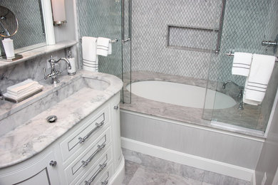 Example of a mid-sized classic master gray tile marble floor bathroom design in Other with recessed-panel cabinets, white cabinets, gray walls, an integrated sink and marble countertops
