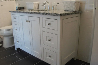 Inspiration for a mid-sized timeless 3/4 white tile and porcelain tile slate floor and gray floor bathroom remodel in Richmond with recessed-panel cabinets, white cabinets, a one-piece toilet, blue walls, an undermount sink and granite countertops
