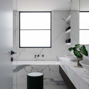 Contemporary bathroom in Sydney with an undermount tub, white tile, stone slab, a vessel sink, white floor and white benchtops.