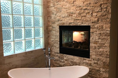 Inspiration for a large mediterranean master brown tile and ceramic tile ceramic tile and brown floor bathroom remodel in Houston