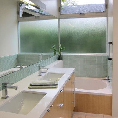 Inspiration for a modern blue tile and glass tile alcove bathtub remodel in Los Angeles with an undermount sink, flat-panel cabinets, light wood cabinets and white countertops