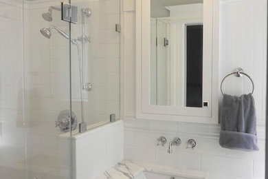 Inspiration for a small timeless master white tile and ceramic tile mosaic tile floor alcove shower remodel in San Francisco with shaker cabinets, white cabinets, blue walls, an undermount sink, marble countertops and a one-piece toilet