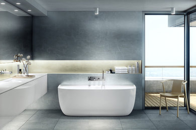Freestanding bathtub - mid-sized modern master gray tile and stone slab cement tile floor and gray floor freestanding bathtub idea in Vancouver with flat-panel cabinets, white cabinets, gray walls, an undermount sink and solid surface countertops