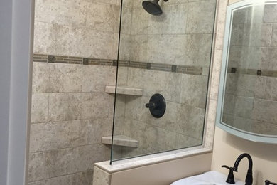 Small ornate 3/4 multicolored tile and porcelain tile marble floor doorless shower photo in Omaha with furniture-like cabinets, a two-piece toilet, an undermount sink and marble countertops