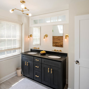 Transitional 3/4 light wood floor and beige floor bathroom photo in Philadelphia with shaker cabinets, black cabinets, beige walls and an undermount sink