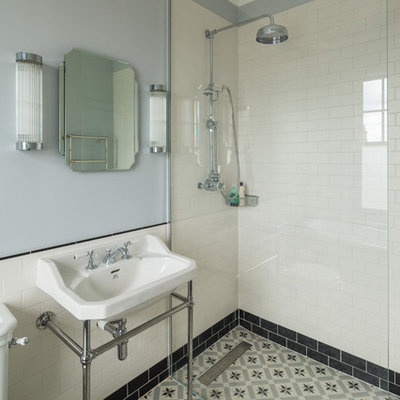 Bathroom - victorian 3/4 bathroom idea in London with blue walls and a wall-mount sink