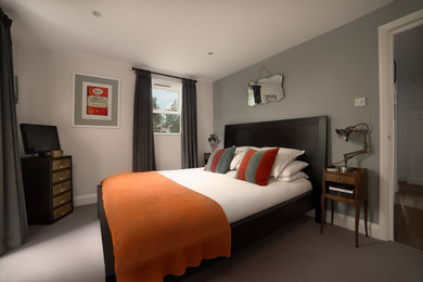 This is an example of a medium sized modern bedroom in London.