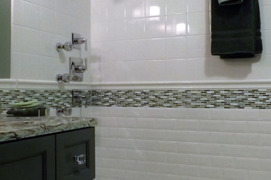 Example of a mid-sized classic white tile and ceramic tile marble floor and white floor bathroom design in Other with gray cabinets, a one-piece toilet, green walls, an undermount sink, quartzite countertops and furniture-like cabinets