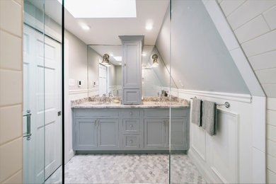 Mid-sized eclectic master white tile and porcelain tile marble floor and multicolored floor walk-in shower photo in Other with beaded inset cabinets, gray cabinets, a two-piece toilet, gray walls, an undermount sink, marble countertops and a hinged shower door