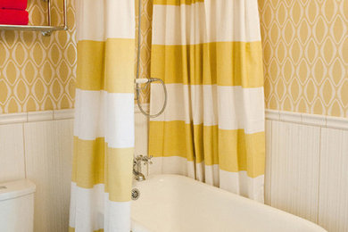 Freestanding bathtub - contemporary freestanding bathtub idea in Austin with a two-piece toilet and yellow walls