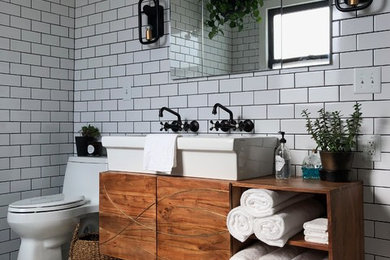 Mid-sized minimalist master white tile and ceramic tile ceramic tile and white floor bathroom photo in St Louis with furniture-like cabinets, medium tone wood cabinets, a one-piece toilet, white walls, a trough sink and wood countertops