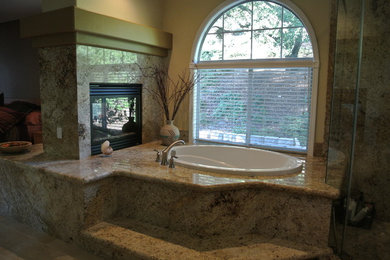 Example of a large tuscan master beige tile and stone slab ceramic tile and beige floor bathroom design in Sacramento with raised-panel cabinets, beige cabinets, a two-piece toilet, yellow walls, an undermount sink, granite countertops and a hinged shower door