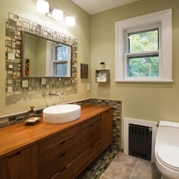 Vintage sideboard, glass accent tile and modern plumbing fixtures