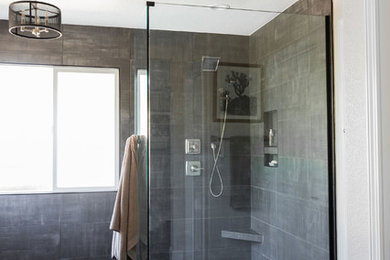 Mid-sized trendy master gray tile and ceramic tile vinyl floor and brown floor bathroom photo in Sacramento with flat-panel cabinets, gray cabinets, a two-piece toilet, white walls, an undermount sink, quartz countertops and white countertops