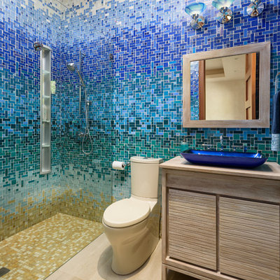 Walk-in shower - tropical 3/4 beige tile, blue tile, green tile, white tile and mosaic tile beige floor walk-in shower idea in Hawaii with flat-panel cabinets, light wood cabinets, a vessel sink, wood countertops and beige countertops