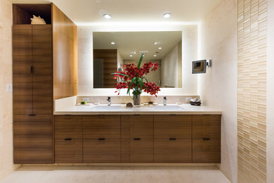 Inspiration for a mid-sized contemporary master beige tile and limestone tile limestone floor and beige floor bathroom remodel in Hawaii with flat-panel cabinets, medium tone wood cabinets, a one-piece toilet, beige walls and an undermount sink