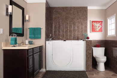 Modelo de cuarto de baño tradicional con lavabo bajoencimera, paredes beige y puertas de armario de madera en tonos medios