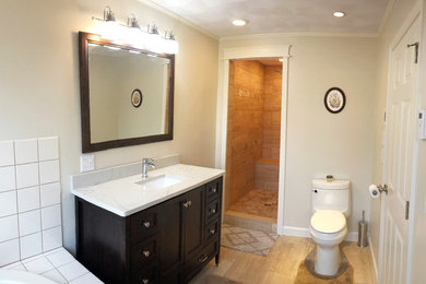Inspiration for a mid-sized timeless master white tile and ceramic tile ceramic tile and beige floor bathroom remodel in Providence with shaker cabinets, dark wood cabinets, beige walls, an undermount sink, granite countertops and beige countertops