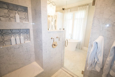 Walk-in shower with built-in seating and shelving for added comfort