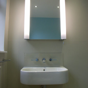 wall hung basin with illuminated mirror cabinet above